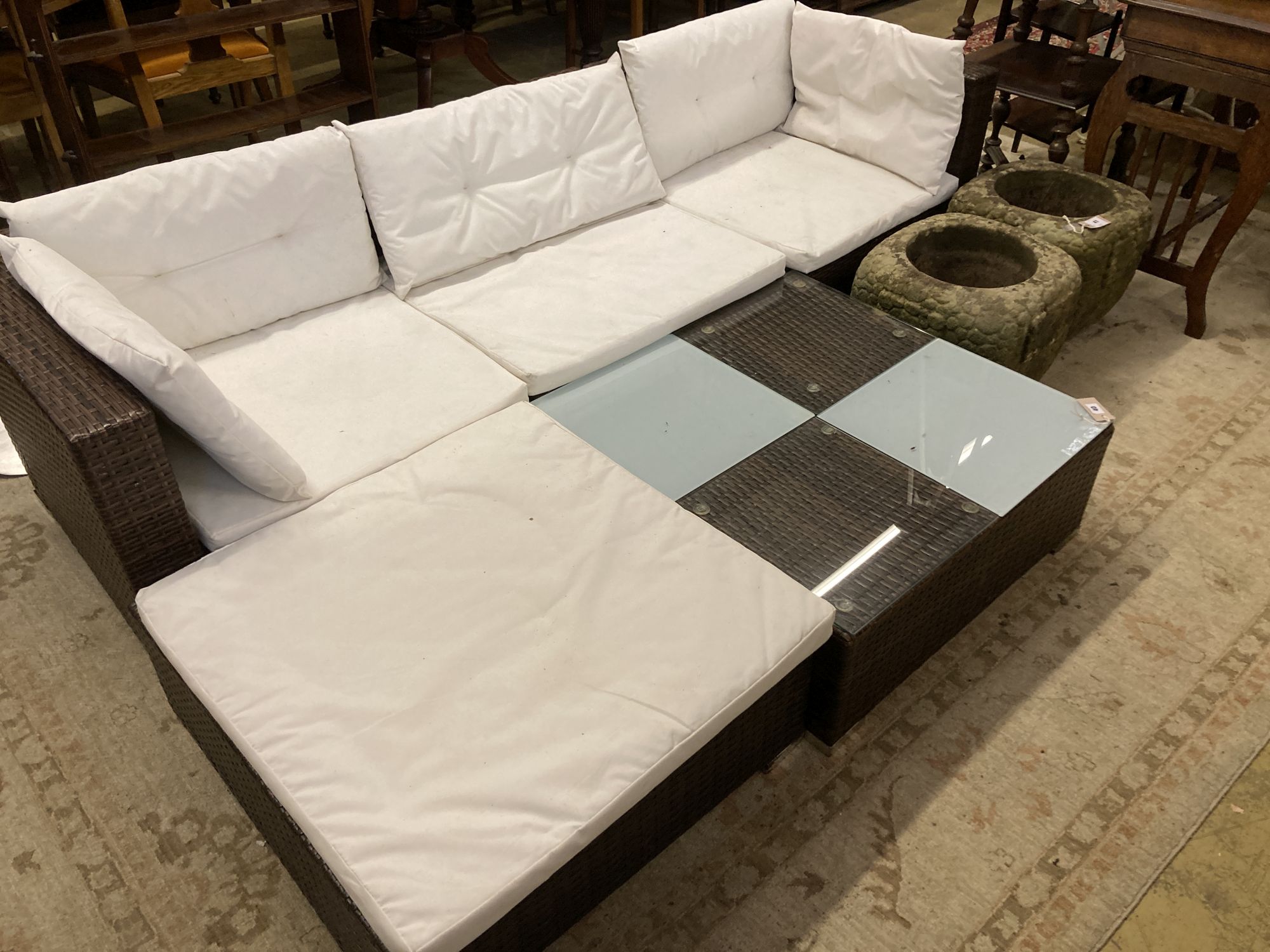 A rattan garden sofa, foot stool and glass top table, sofa width 210cm depth 70cm height 54cm